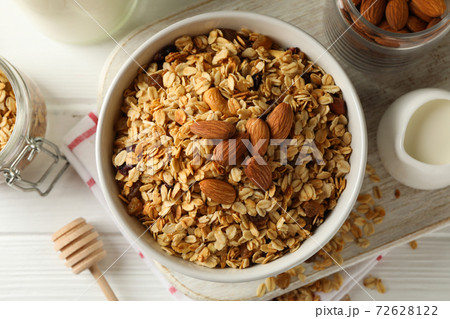 Concept of tasty breakfast with granola on white wooden background 72628122