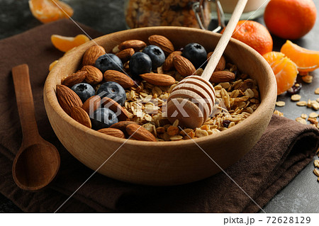 Concept of tasty breakfast with granola on black smokey background 72628129