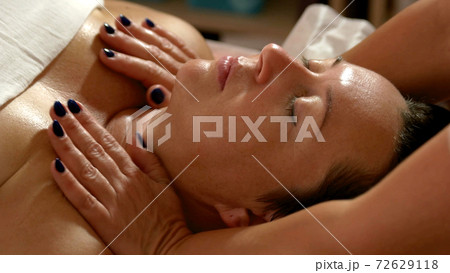 Relaxed woman having body massage at spa salon. Relaxed woman having body massage at spa salon. 72629118