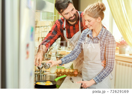 Caucasian man and woman cooking. Caucasian man and woman cooking. 72629169