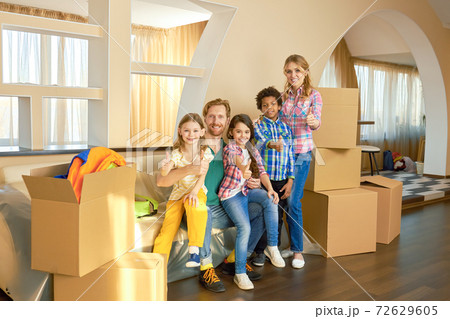 Family showing thumbs up indoor. Family showing thumbs up indoor. 72629605