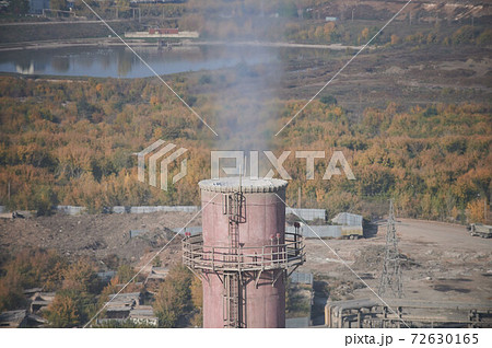 Coal processing plant. smoke of pipes pollutes atmosphere of the city. Concept of oil and gas processing, pollution of environment, emissions into water resources, oncological diseases, cancer. Coal processing plant. smoke of pipes pollutes atmosphere of the city. Concept of oil and gas processing, pollution of environment, emissions into water resources, oncological diseases, cancer. 72630165