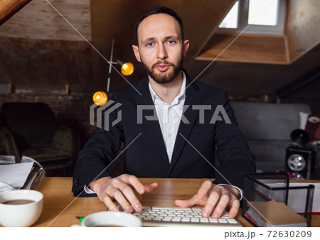 Young man talking, working during videoconference with colleagues at home office 72630209
