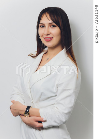 Portrait of attractive smiling female dentist with hands folded. 72631149