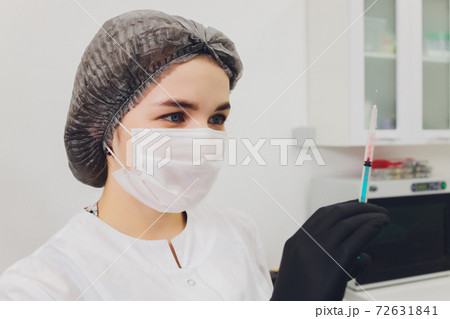 Dentist and patient choosing treatment in a consultation with medical equipment in the background. 72631841
