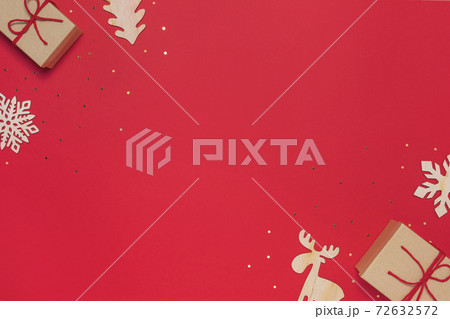 Craft present with baubles on red background 72632572