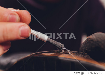 glue application with a brush, shoe repair. glue application with a brush, shoe repair. 72632765