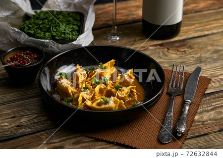 Italian ravioli stuffed with meat closeup on a black plate. rustic style 72632844