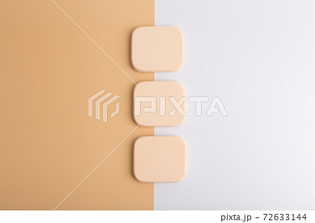 Three make up sponges on beige and pink background Three make up sponges on beige and pink background 72633144