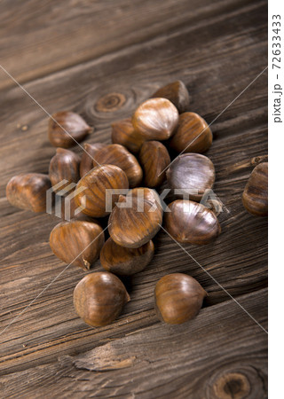 Chestnuts on wooden background 72633433
