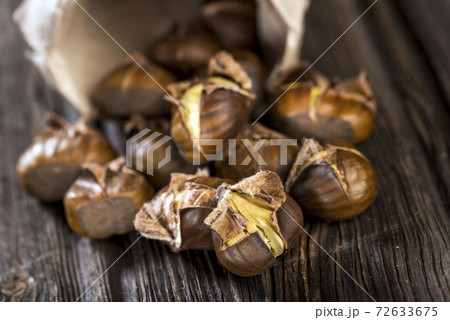 Chestnuts on wooden background Chestnuts on wooden background 72633675