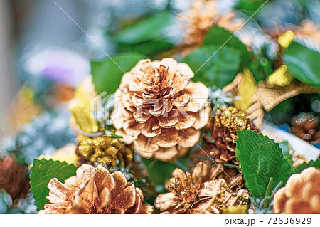 A decorative artificial golden pine cone close up 72636929