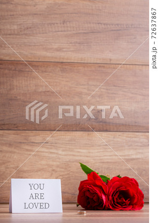 You are loved holiday card next to two red roses 72637867