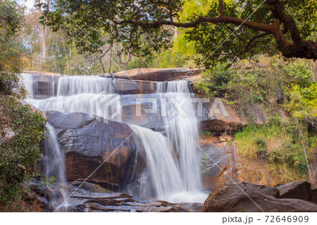 Waterfall with stone foreground in forest Waterfall with stone foreground in forest 72646909