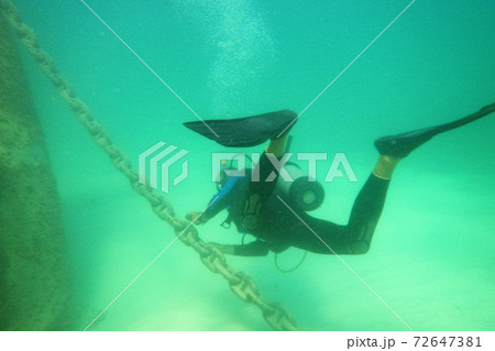 Male scuba diver with equipment diver swims in water Male scuba diver with equipment diver swims in water 72647381