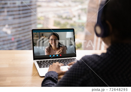 Back view of woman talk on video call with colleague Back view of woman talk on video call with colleague 72648293