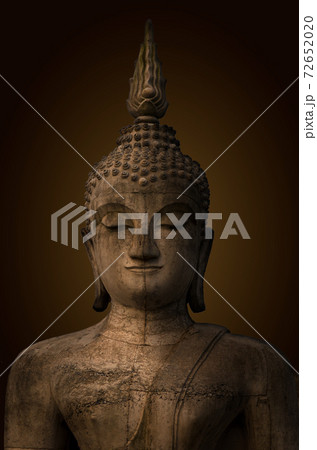 Buddha statue used as amulets of Buddhism religion.The ancient Buddha, dark brown background. 72652020