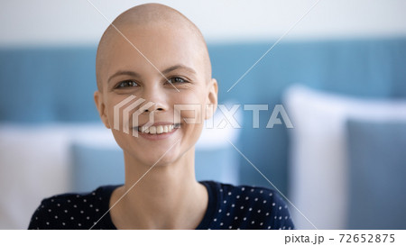 Smiling female having oncology look at camera motivated to survive 72652875