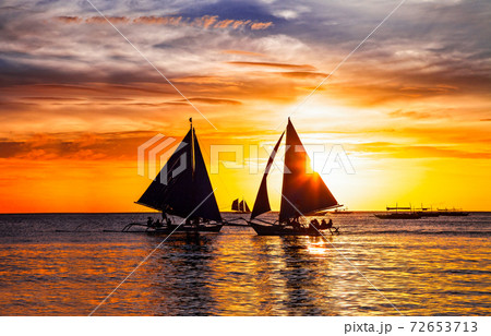 amazing tropical sunset and silhouette of sailing boats in Boracay island in Philippines 72653713
