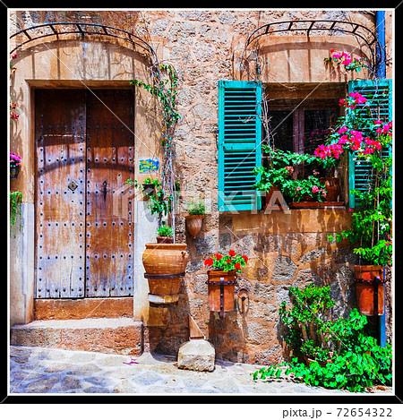 Charming old streets decorated with flowers. 72654322