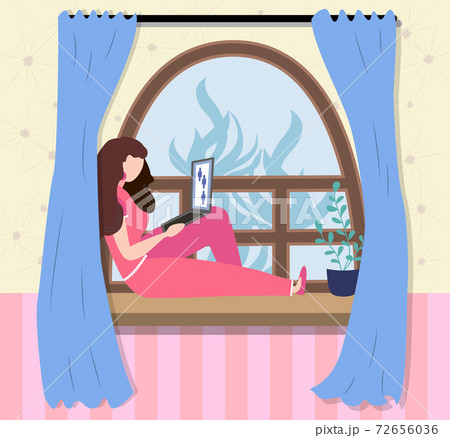 A woman works at a laptop while sitting on the windowsill at home. Freelance concept, quarantine due to covid-19 A woman works at a laptop while sitting on the windowsill at home. Freelance concept, quarantine due to covid-19 72656036