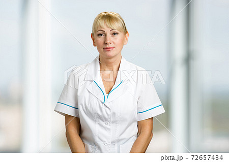 Portrait of nurse in white uniform. 72657434