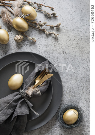 Easter table setting with golden and black decor. 72660462