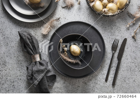 Easter table setting with black and golden decor. Easter table setting with black and golden decor. 72660464