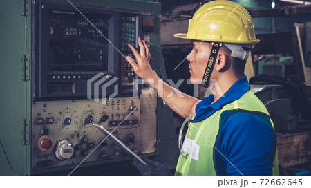 Smart factory worker using machine in factory workshop 72662645
