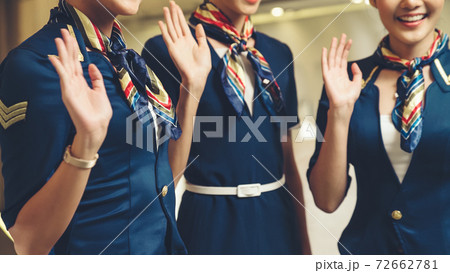 Cabin crew waving hand for greeting or goodbye Cabin crew waving hand for greeting or goodbye 72662781
