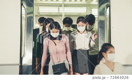 Crowd of people wearing face mask on a crowded public subway train travel 72663026