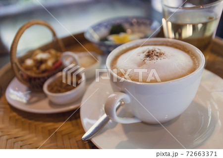 Cappuccino coffee served in a Thai style coffee shop Cappuccino coffee served in a Thai style coffee shop 72663371