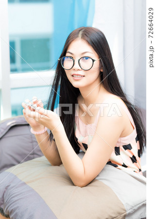 Beautiful asian women use smartphone on bed in modern bed room 72664029