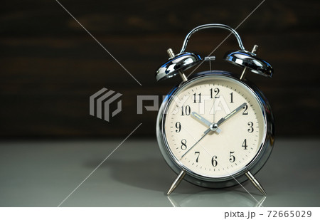 Retro alarm clock on table Retro alarm clock on table 72665029