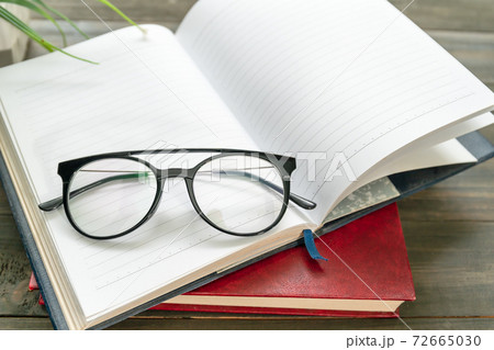 Reading glasses put on open book Reading glasses put on open book 72665030
