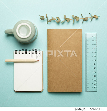 Notebook, mug cup, pencil, ruler on sky blue background. flat lay, top view, copy space. Work and study place 72665196