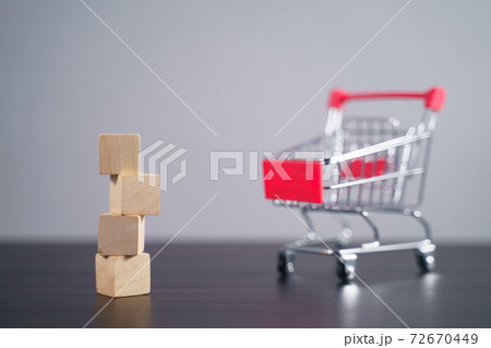 Close up shot of empty wooden blocks with shopping cart. Close up shot of empty wooden blocks with shopping cart. 72670449