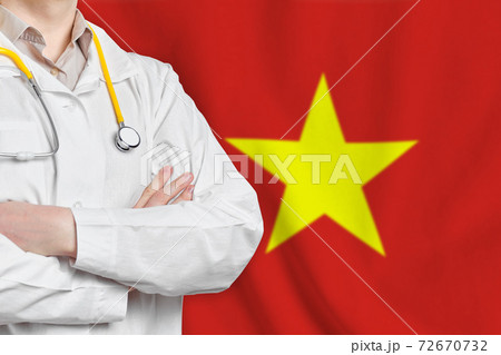 Socialist Republic of Vietnam healthcare concept with doctor on flag background. Medical insurance, work or study in the country. 72670732