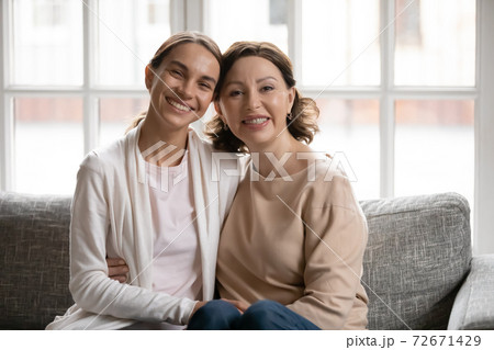 Head shot portrait smiling middle aged mother and grownup daughter 72671429