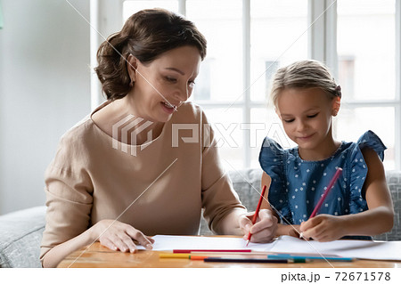 Close up smiling mature grandmother and granddaughter drawing together 72671578