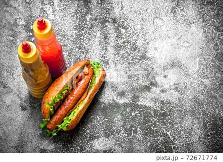 Street food. Hotdog beef with greens in a fresh bun. 72671774