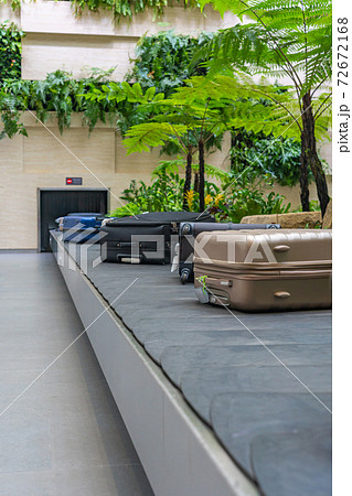 Passenger luggage on conveyor belt at arrival terminal in airport Passenger luggage on conveyor belt at arrival terminal in airport 72672168