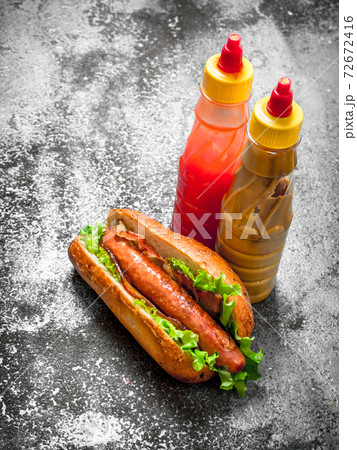 Street food. Hotdog beef with greens in a fresh bun. 72672416