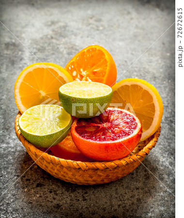 Sliced citrus fruits in a basket. 72672615