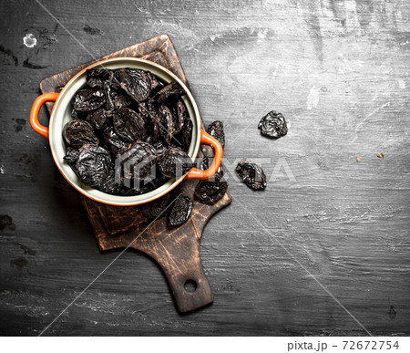 Prunes in a bowl . 72672754