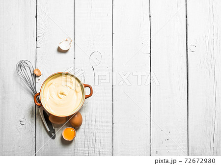 Mayonnaise in bowl with whisk. Mayonnaise in bowl with whisk. 72672980