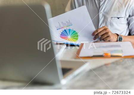 Close up photo of businessman reading sale report 72673324