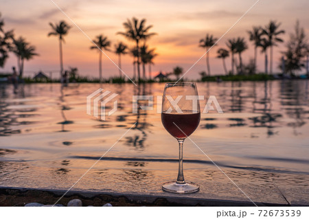 Glass of red wine at luxury beach resort Glass of red wine at luxury beach resort 72673539