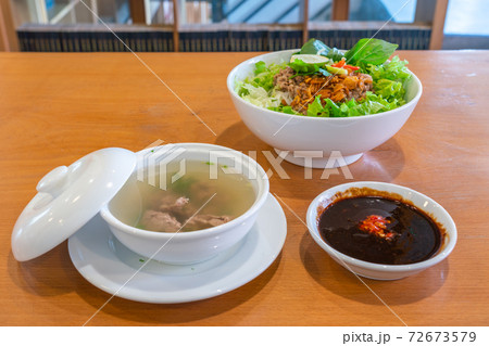 Delicious pork noodle soup and herbs in Asian restaurant 72673579