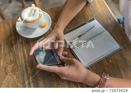 Man hand using phone in the coffee shop Man hand using phone in the coffee shop 72673629